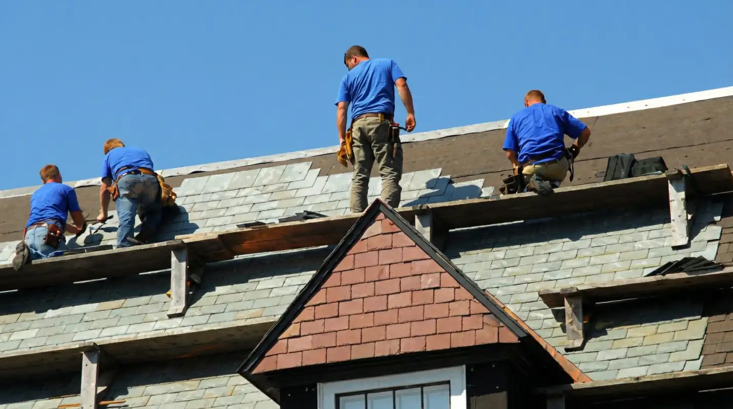 Roof replacement in progress with a team of professional contractors installing new shingles on a residential home in Hialeah, FL